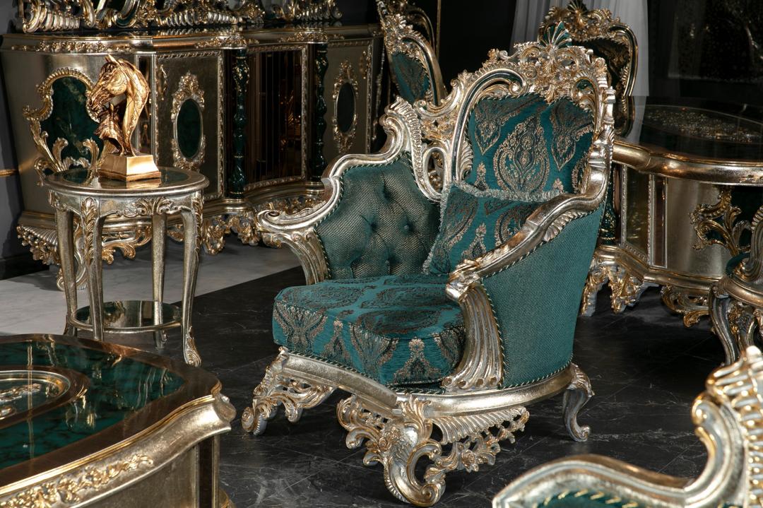 Opulent furniture set with teal velvet chairs and gold accents in a luxurious room.